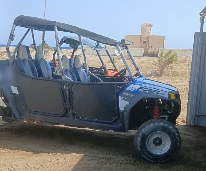 Four-seat family buggy with roll cage and roof on the sand near Marsa Alam