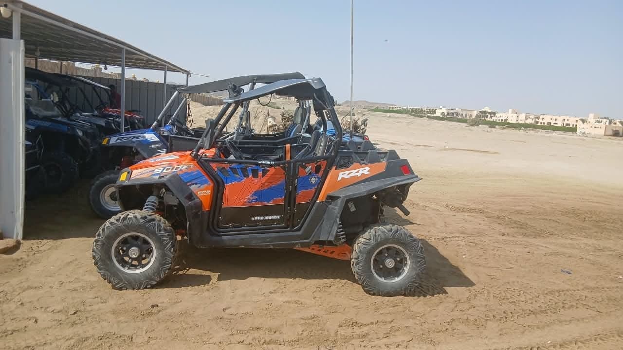 Orange two-seat buggy with roll cage ready for a private buggy safari in Marsa Alam